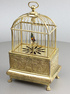 Vintage miniature gilt brass singing bird in cage, by Eschle