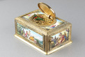 Tooled gilt bronze and enamel singing bird box