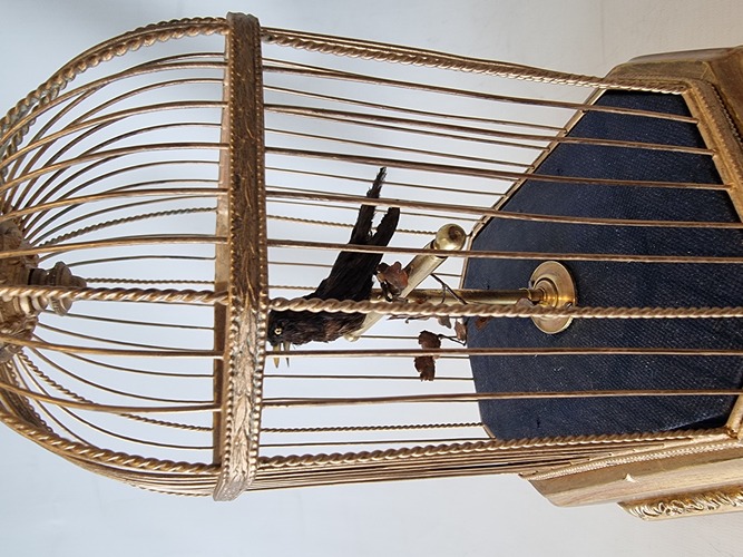 Vintage single singing bird in cage, by Karl Griesbaum