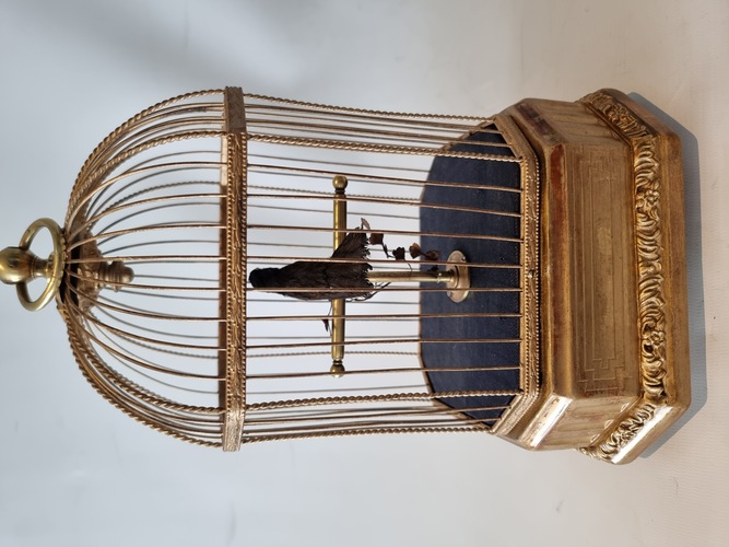 Vintage single singing bird in cage, by Karl Griesbaum