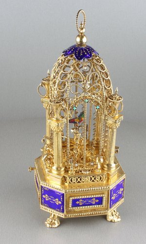Miniature silver gilt, enamel, mother-of-pearl and turquoise mounted singing bird-in-cage, by Karl Griesbaum