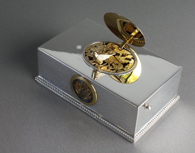 Contempary sterling silver, gold and diamond singing bird box with timepiece, by Reuge