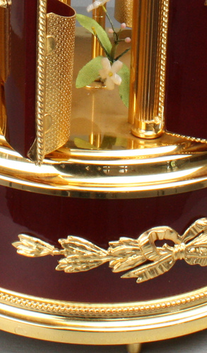 A contemporary maroon lacquer and metal gilt singing bird cigar dispenser carousel, by Reuge