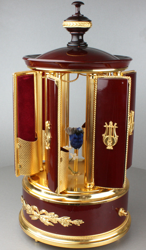 A contemporary maroon lacquer and metal gilt singing bird cigar dispenser carousel, by Reuge